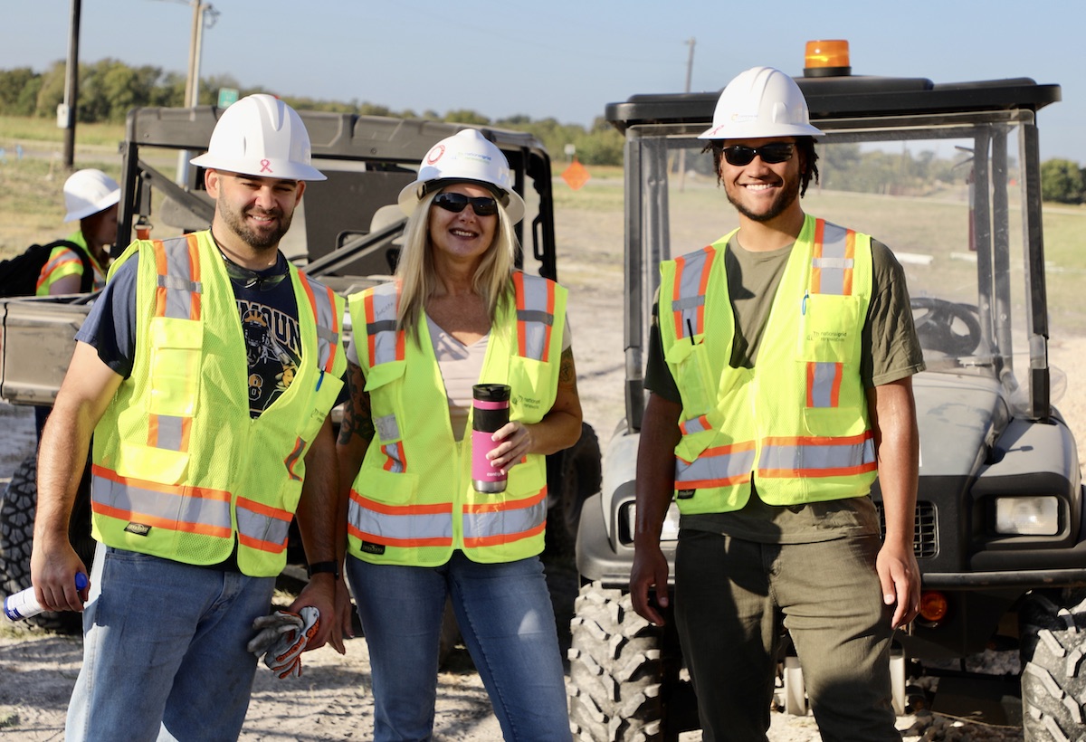Three people in construction vests