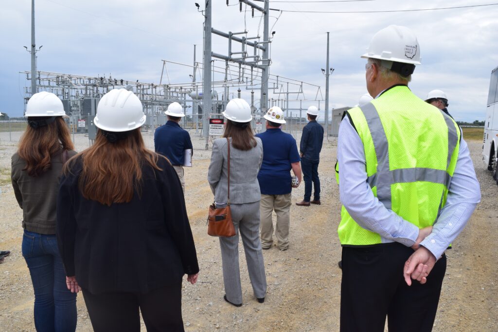 People standing with hard hats at the start of operations at Amazon Solar Farm Ohio - Yellowbud