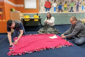 People making tie blankets