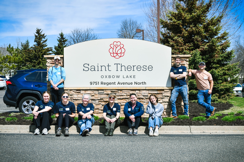 Group next to St. Therese sign